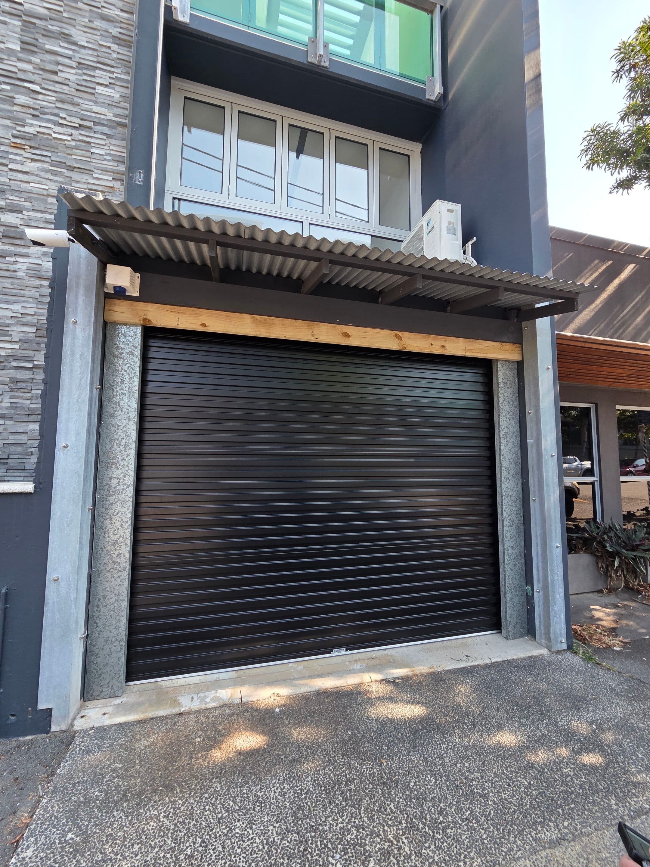 Black roller door closed and secured on the Sunshine Coast